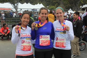 Three Aztec Recreation employees celebrating after completing the Carlsbad Half Marathon